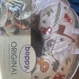 Boppy Feeding Pillow with Animal Print in White, Brown, Green, Red